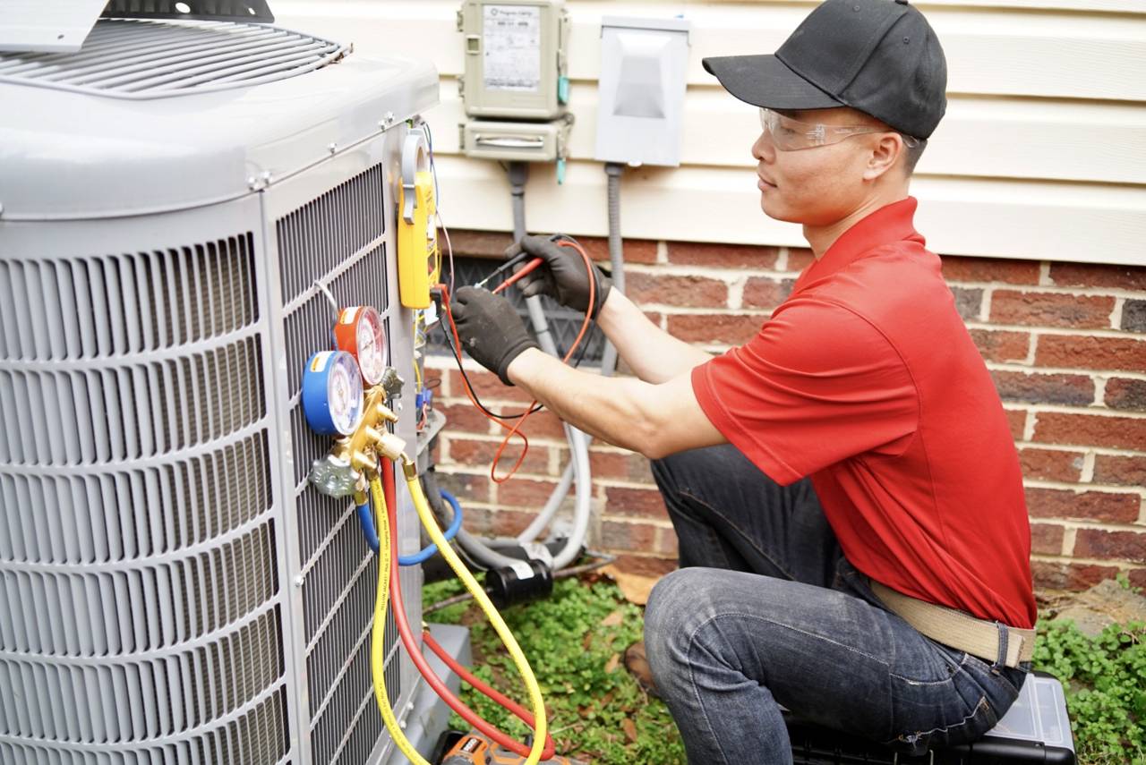 John Tran working on a condenser with manifold gauges connected